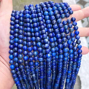 Detailed macro view of natural deep blue lapis lazuli round beads for DIY jewelry making