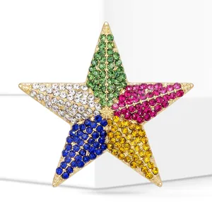 Detailed macro view of a colorful rhinestone five-pointed star brooch in gold-tone metal