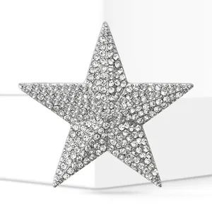 Detailed view of vintage star brooch fully paved with sparkling rhinestones