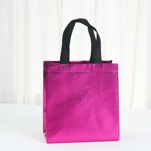 Close-up detail of fuchsia metallic laser non-woven gift bag with durable black handles.