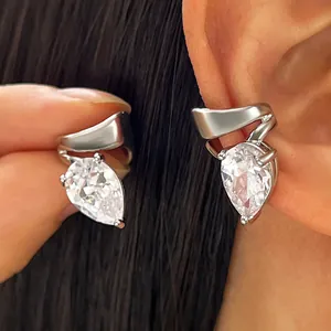 Close-up of elegant silver twisted line ear cuff featuring a sparkling pear-shaped zircon stone.