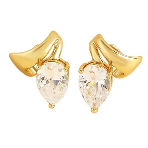 Detail of gold-tone clip-on earrings with pear-cut zircon and twisted line design