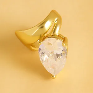 Macro view of elegant gold twisted ear cuff with a large pear-shaped sparkling cubic zirconia