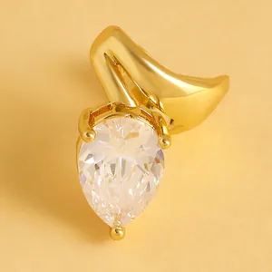 Detailed close-up of an elegant gold ear cuff featuring a large teardrop zircon stone