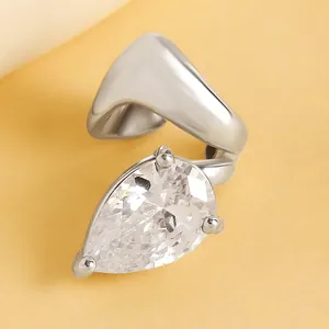 Macro detail of twisted silver-tone ear cuff featuring a pear-cut clear cubic zirconia.