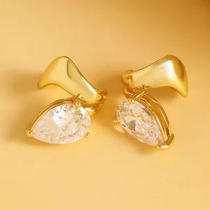 Detailed view of luxury pear-shaped zirconia clip-on earrings with twisted gold lines