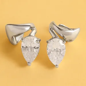 Detailed macro view of silver-tone ear clips featuring elegant pear-shaped clear zircons.