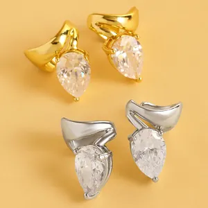 Close-up view of teardrop cubic zirconia clip-on earrings in gold and silver finish