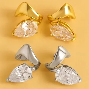 Detail view of luxury twisted line ear clips with pear-cut cubic zirconia stones