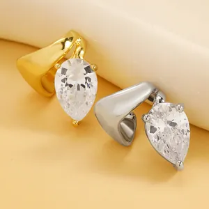 Macro detail of pear-cut cubic zirconia and twisted band on light luxury ear cuff.