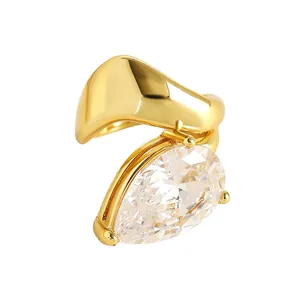 Detailed macro view of gold-finished twisted ear cuff with large pear-cut zirconia