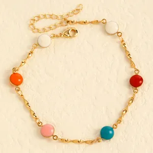 Detailed close-up of gold stainless steel anklet featuring vibrant colorful enamel beads