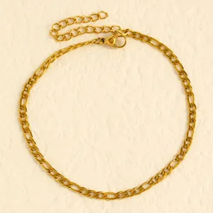 Close-up detail of a minimalist gold Figaro chain anklet for beach vacation style