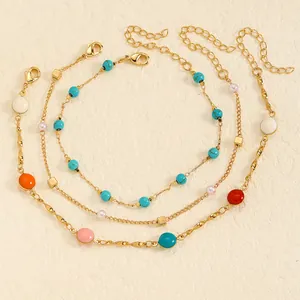 Detail of three-piece stainless steel anklet set with colorful enamel beads