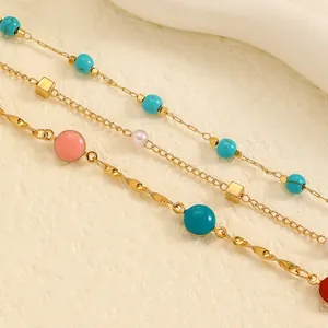 Close-up of stainless steel anklet set with colorful beads and gold twisted chains