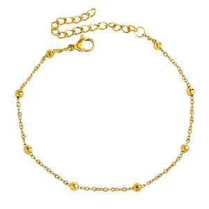 Detailed view of gold-tone stainless steel anklet with polished beads and lobster clasp