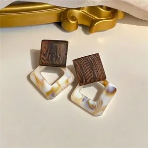 Detail view of vintage wooden and marbled acrylic geometric drop earrings.