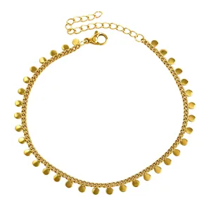Close-up of gold-plated stainless steel anklet with dangling round disc charms