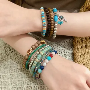Close-up detail of bohemian beaded bracelet set featuring wood, stone and metal charms