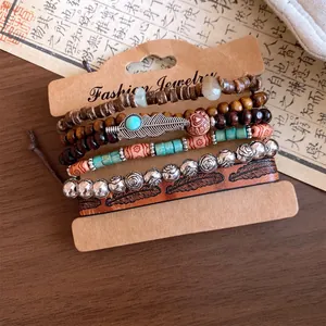 Detailed view of vintage leather and beaded bracelet set featuring feather and flower charms.