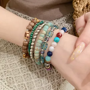 Vintage bohemian stacked beaded bracelet set with wood, stone, and coconut shell beads.