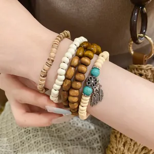 Close-up detail of vintage beaded bracelet set with wood, stone, and leaf charms