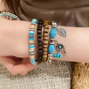 Close-up of retro beaded bracelet set with turquoise stones and leaf charms.