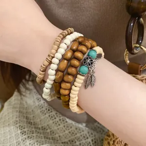 Detailed view of a bohemian beaded bracelet set featuring wood beads and leaf charms