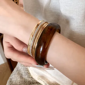5-piece set of resin and gold-tone metal bangles with tortoiseshell and crystal accents