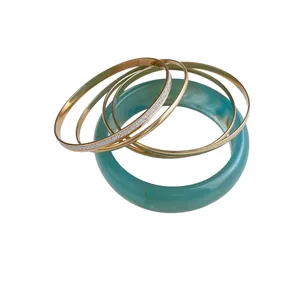 Elegant 5-piece bangle set featuring turquoise resin and gold-toned metal stack rings