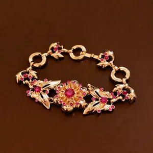 Elegant vintage gold floral bracelet with red rhinestones and butterfly charms