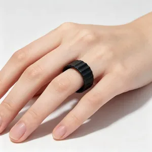 Detailed close-up showing a 9mm wide matte black titanium steel ribbed ring on a finger