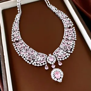 Close-up of premium silver necklace with pink zircons and pearls on brown display