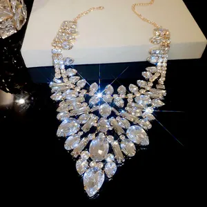Detail of luxury teardrop crystal statement necklace with sparkling gold finish