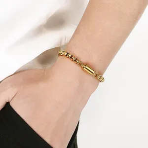 Detail shot of a minimalist gold stainless steel box chain bracelet with magnetic clasp