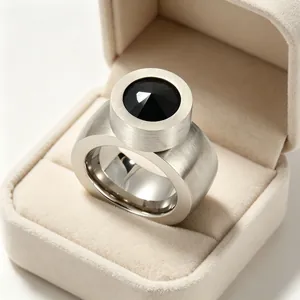Vue détaillée d'une bague large argent brossé avec un grand serti de pierre noire.