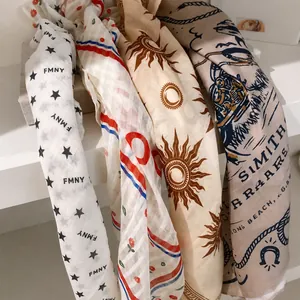 Printed polyester square scarf with Western cowboy patterns for hair or neck styling.