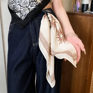 Vintage printed polyester square bandana scarf styled on denim jeans for a bohemian look.