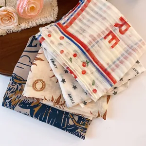 Close-up detail of printed polyester square bandanas with cowboy and star patterns