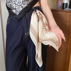 Western-style printed square bandana tied to denim jeans for a stylish and chic look