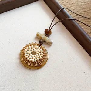 Ethnic style long necklace with resin pendant and beige beads on brown leather cord