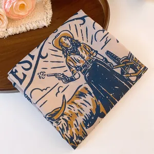 Close-up of vintage Western cowboy and longhorn print on polyester square headscarf