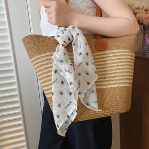 Star print white bandana tied to a straw tote bag showing stylish accessory detail