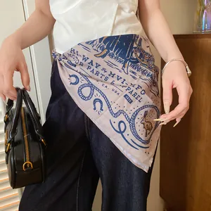 Western cowboy style printed square scarf styled as a waist accessory over jeans