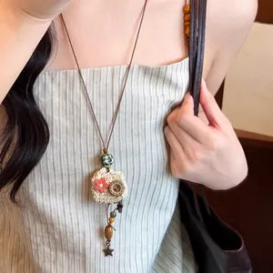 Handmade woven straw hat pendant necklace with beads and red flower for summer gift.