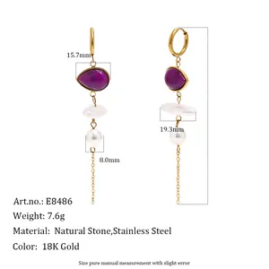 Detailed view of gold-plated stainless steel tassel earrings with purple stones and pearls.