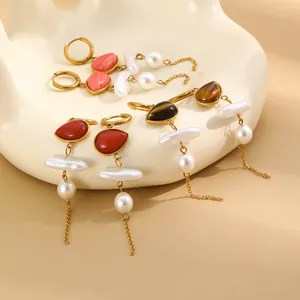Detailed view of gold plated stainless steel tassel earrings with colorful stones and pearls.