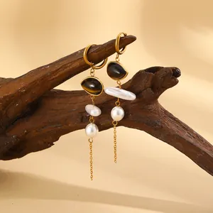 Detailed view of 18K gold plated stainless steel tassel earrings with pearls and beads.