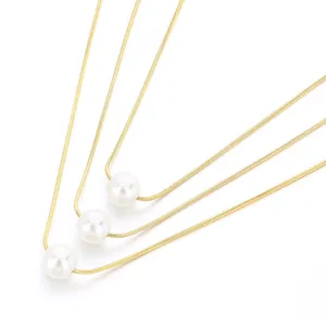 Triple-layered gold titanium steel necklace with white pearls on sleek snake bone chains