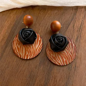 Bohemian wooden rose stud earrings with zebra pattern disk in warm wood tones.